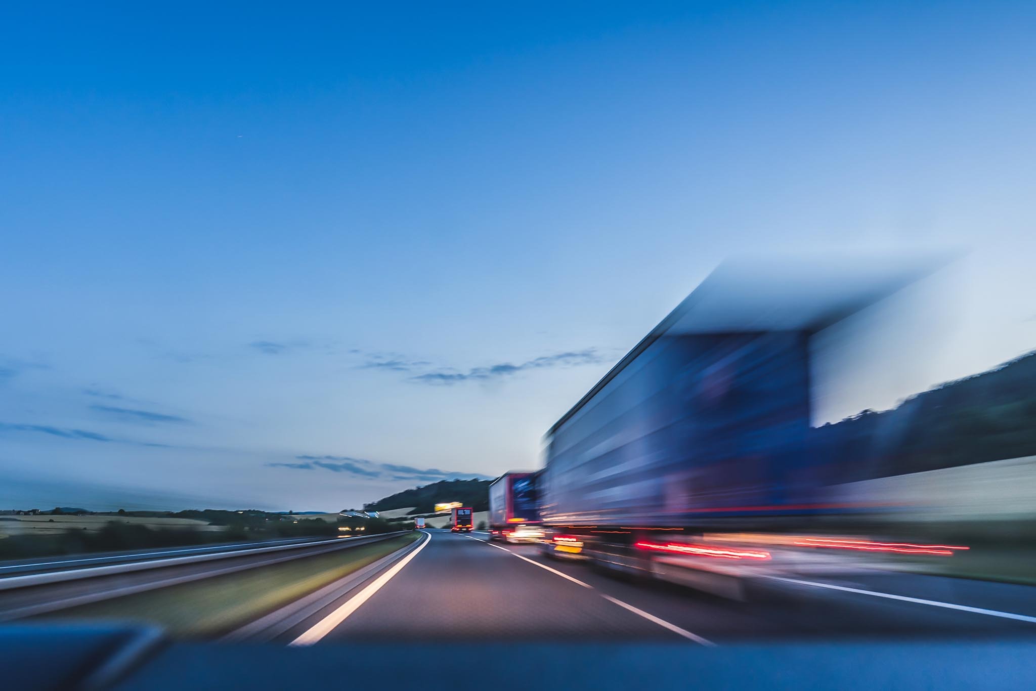 Truck in motion on a highway at dusk