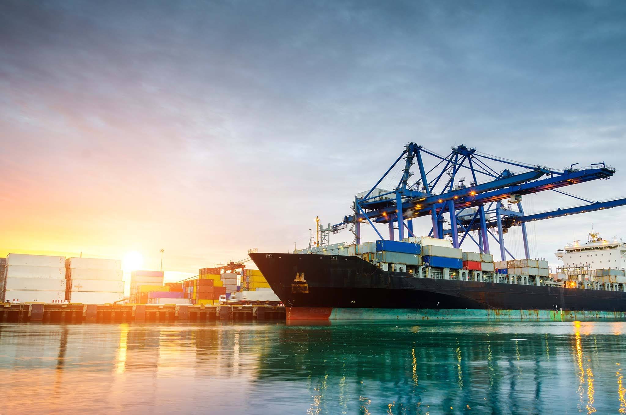 Cargo ship docked at sunset